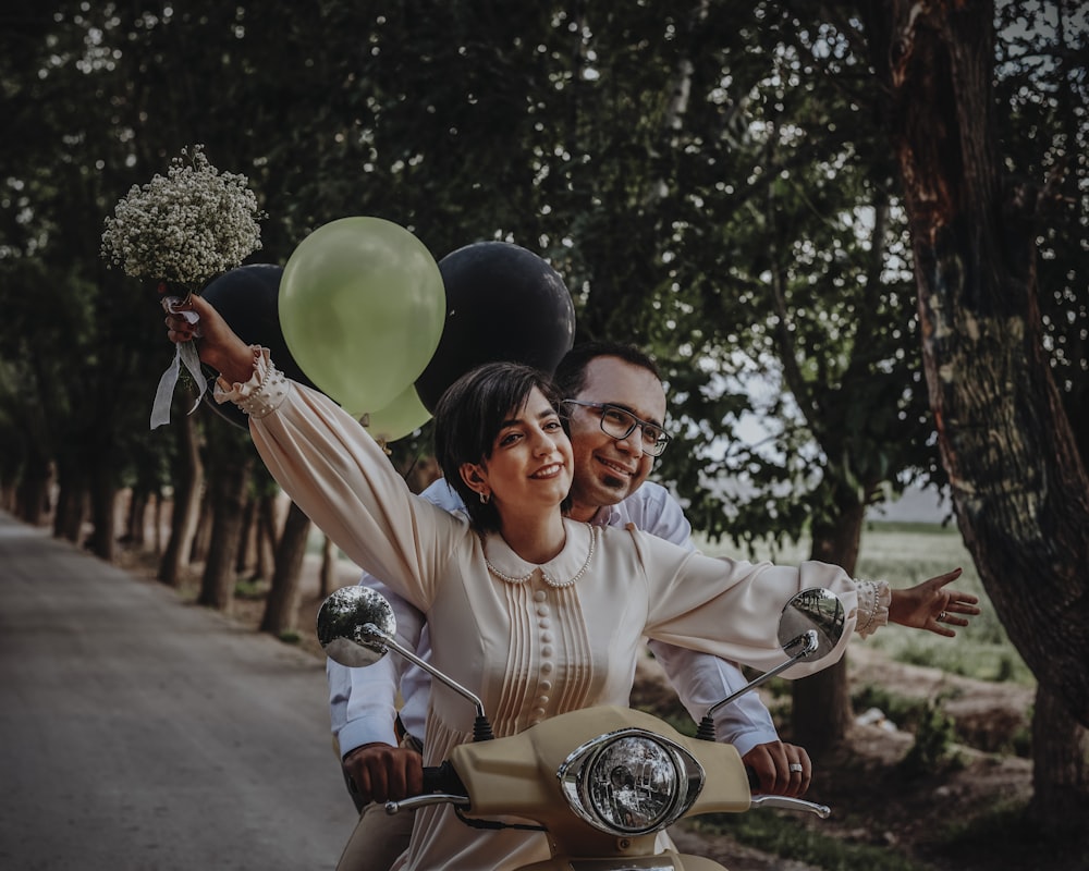 man in white dress shirt holding green balloon