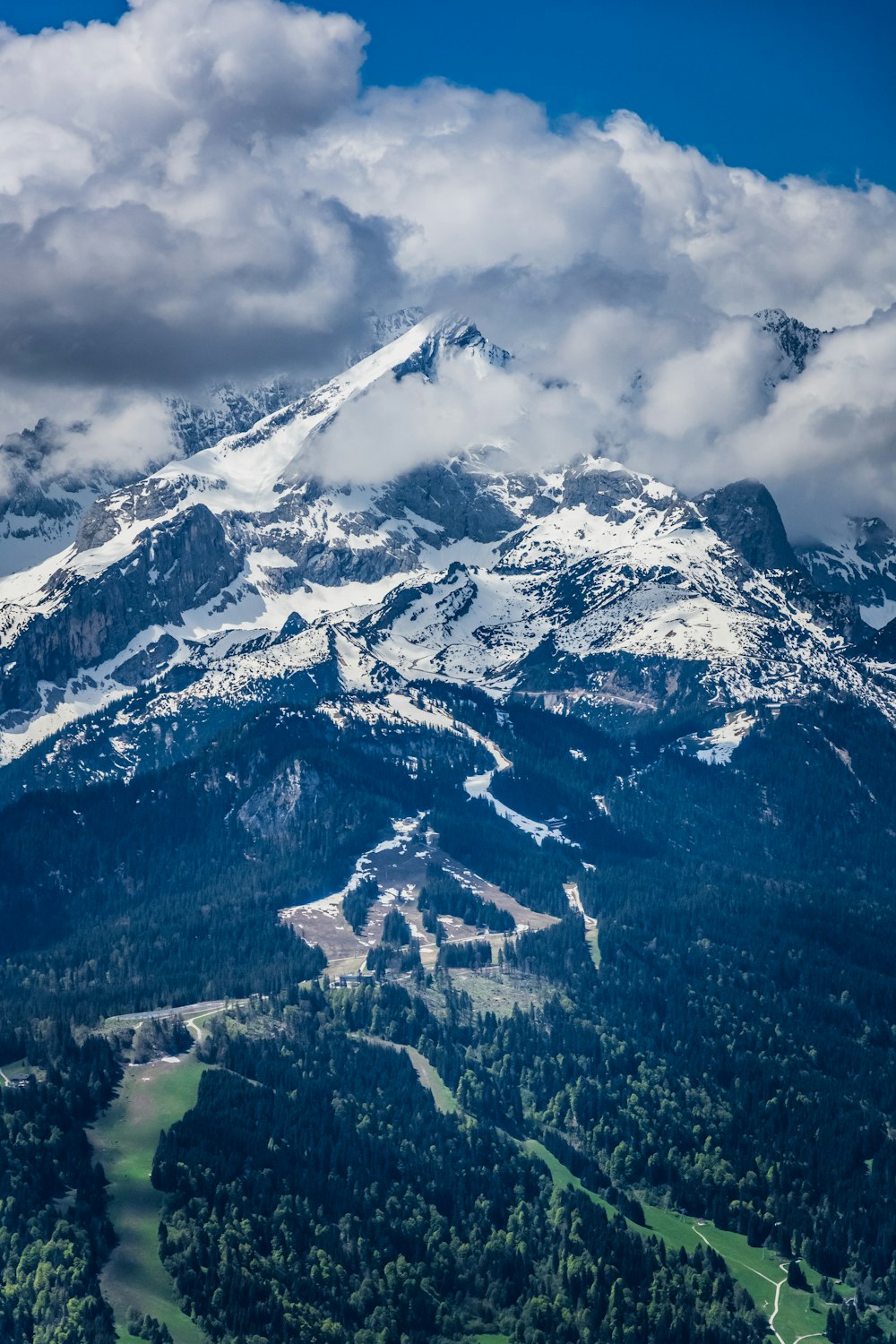 snow covered mountain under cloudy sky during daytime