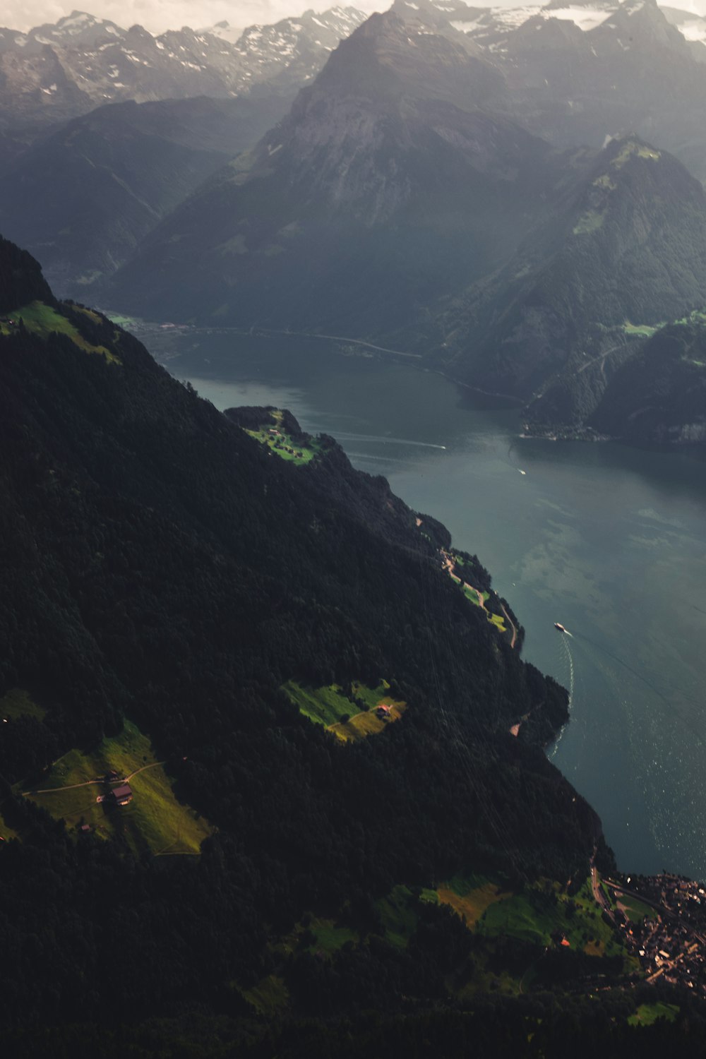 green mountain beside body of water during daytime