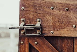 brown wooden door with gray steel handle