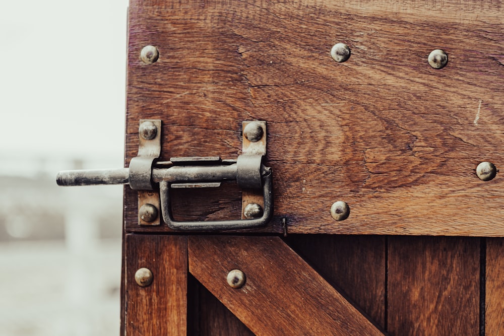 brown wooden door with gray steel handle