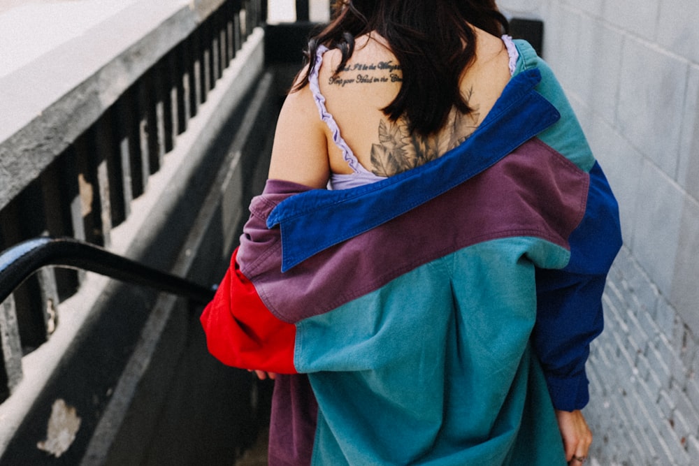 woman in blue spaghetti strap top and red skirt