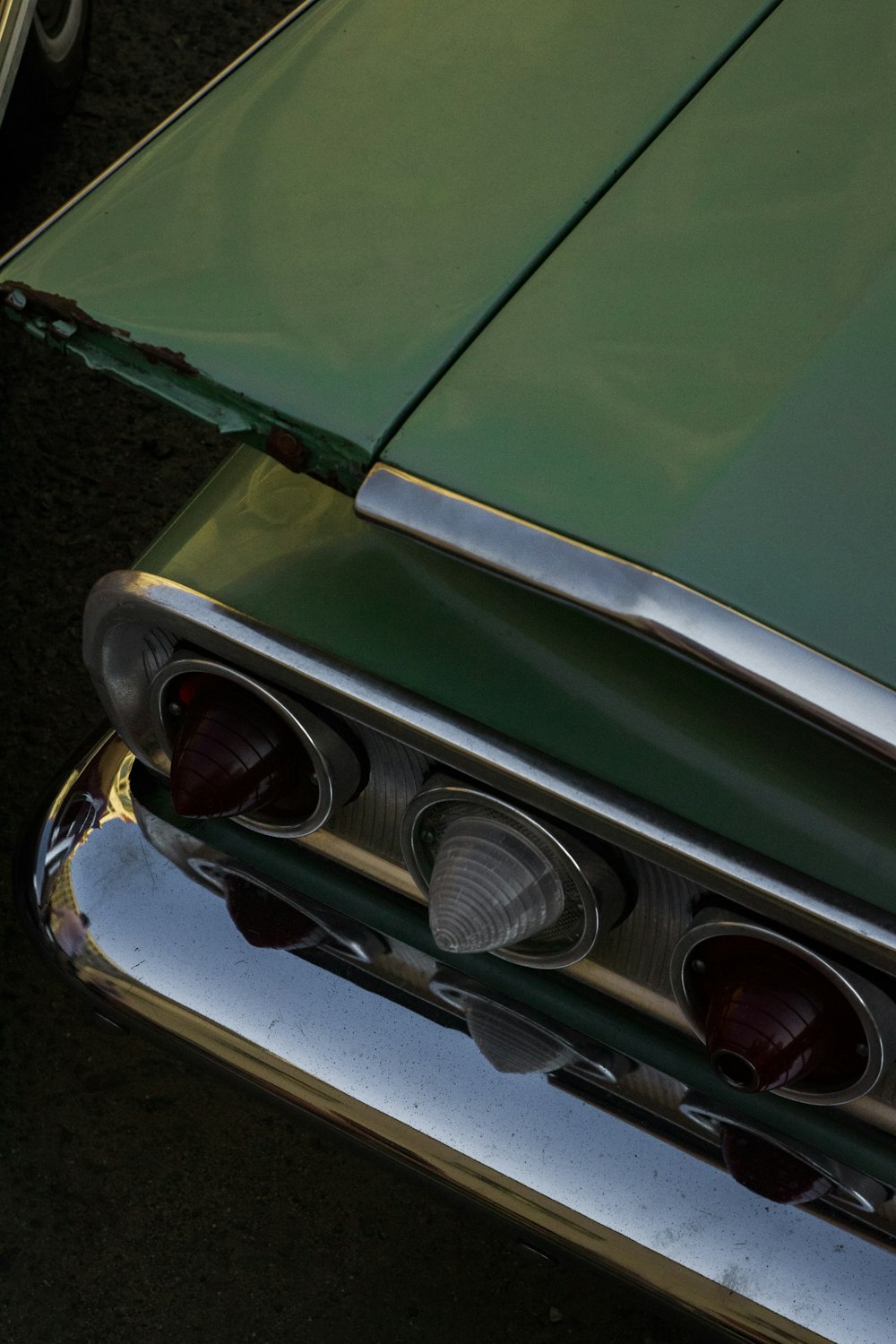 green car on black asphalt road