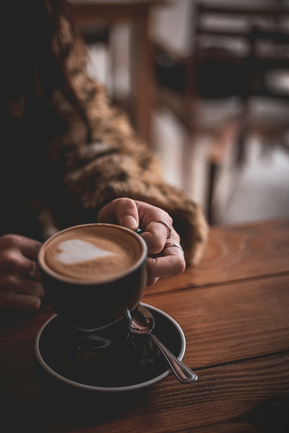 person holding black ceramic mug with coffee