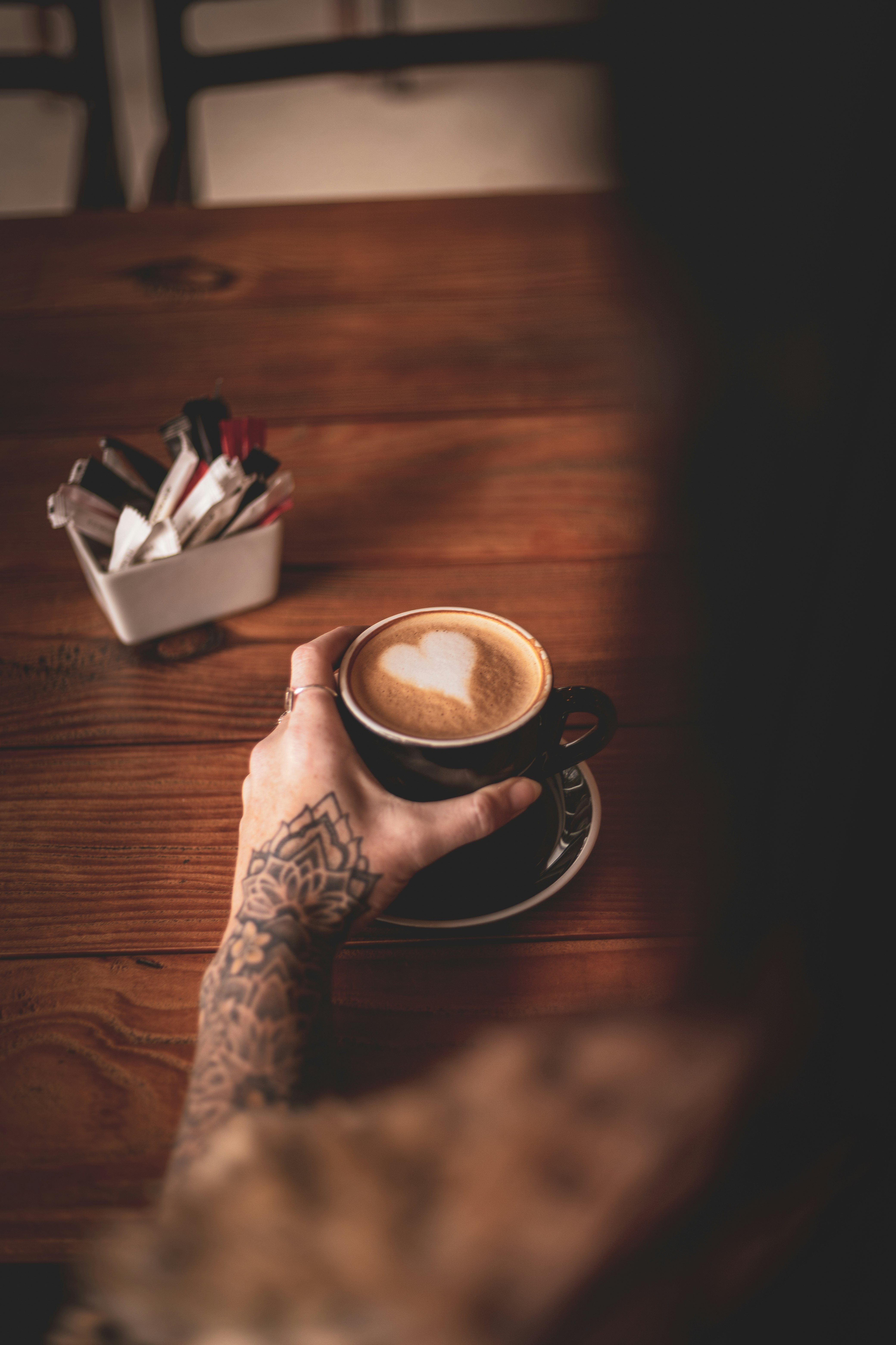 person holding black ceramic mug with coffee