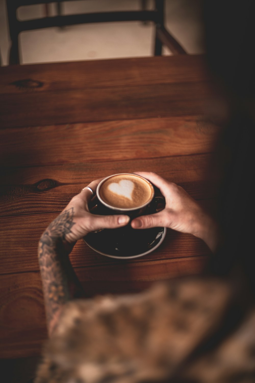 person holding white ceramic mug with coffee