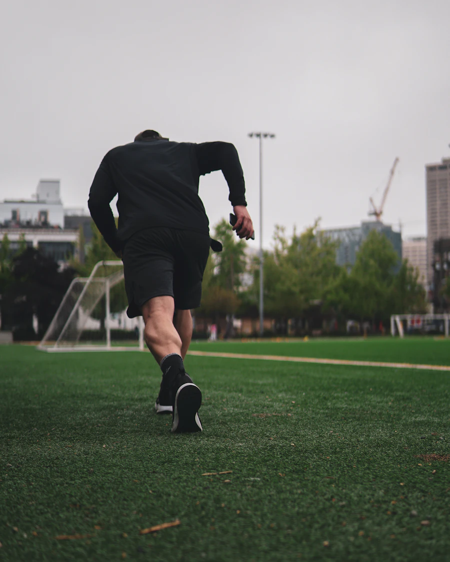Athletic man outdoors running on grass