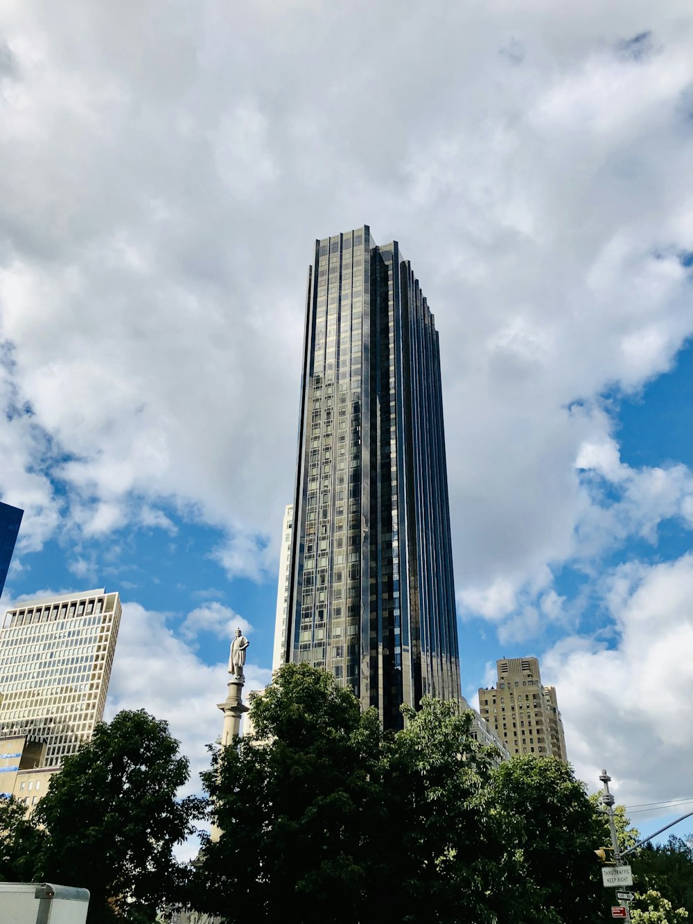 white and blue concrete building under white clouds and blue sky during daytime