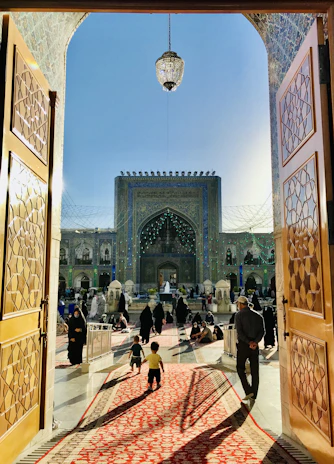 Close-up of a professional concierge welcoming guests at a beautifully decorated riad entrance in Marrakech.