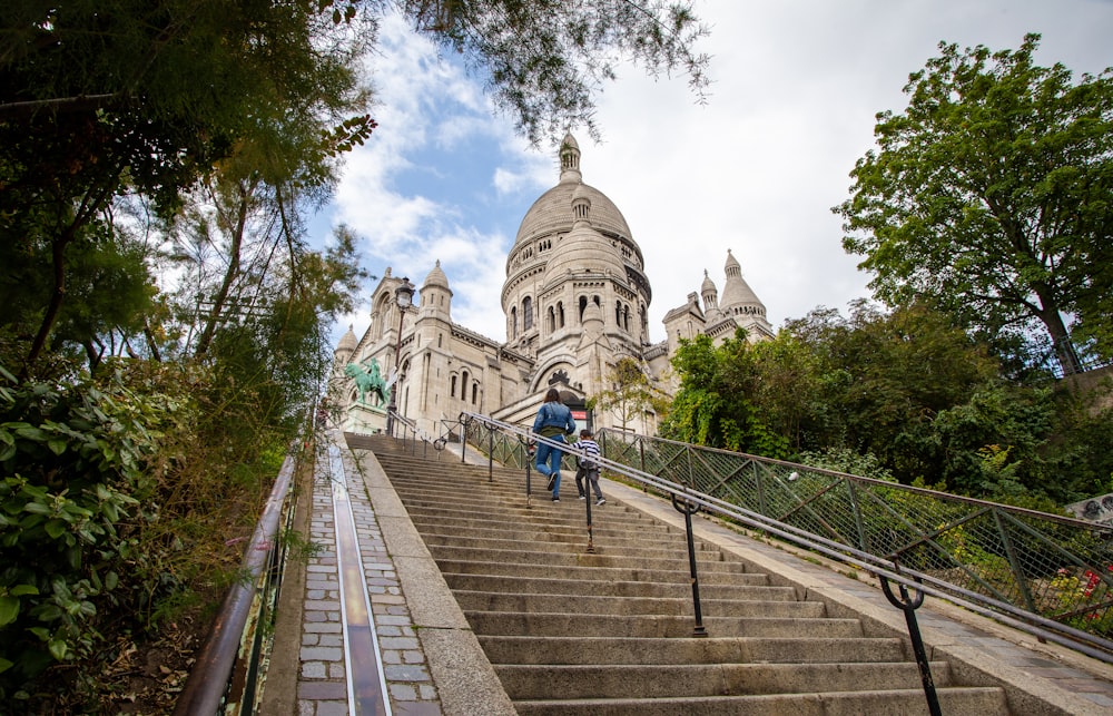 people walking on sidewalk near cathedral during daytime