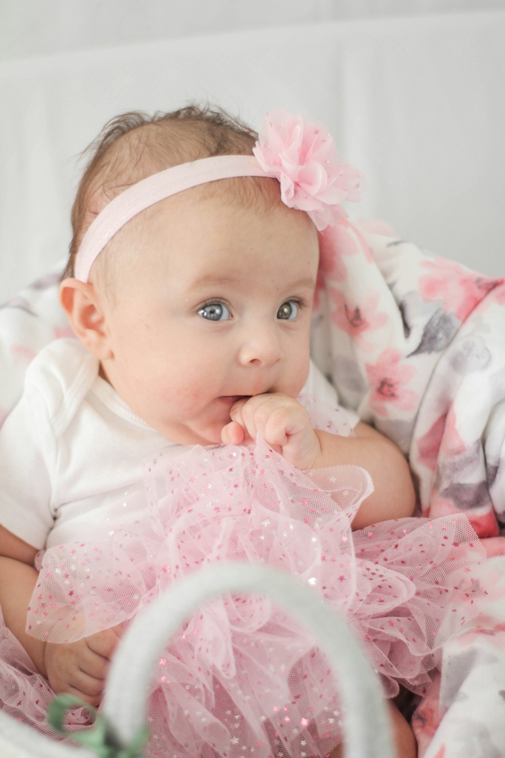 baby in white shirt lying on bed