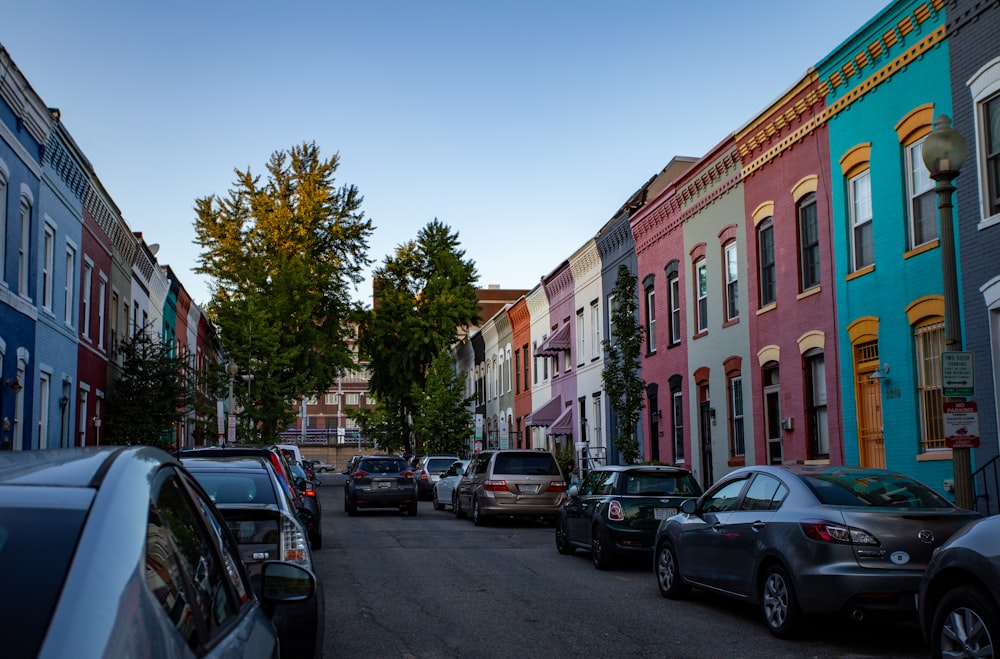 cars parked on side of the road near buildings during daytime