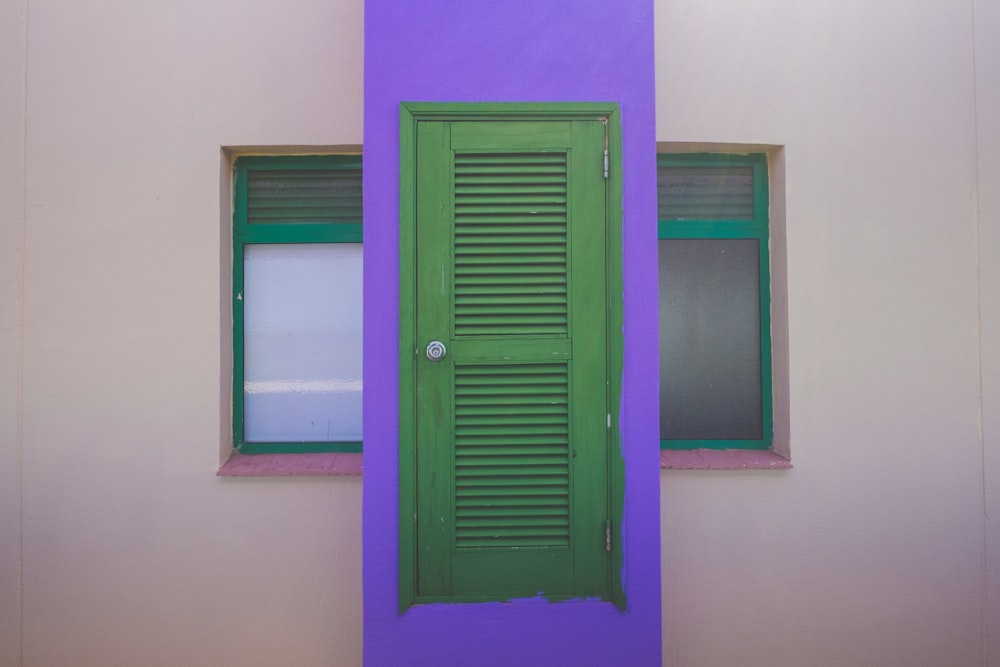 purple wooden door on white painted wall