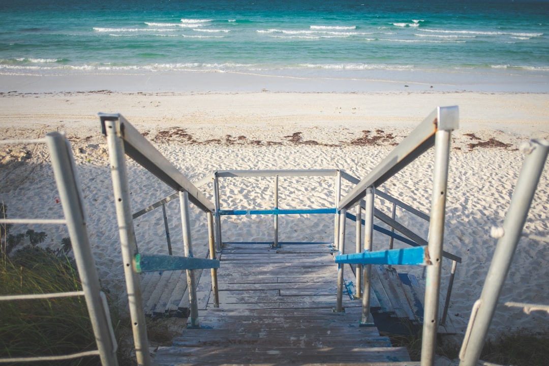 blue metal railings on beach during daytime