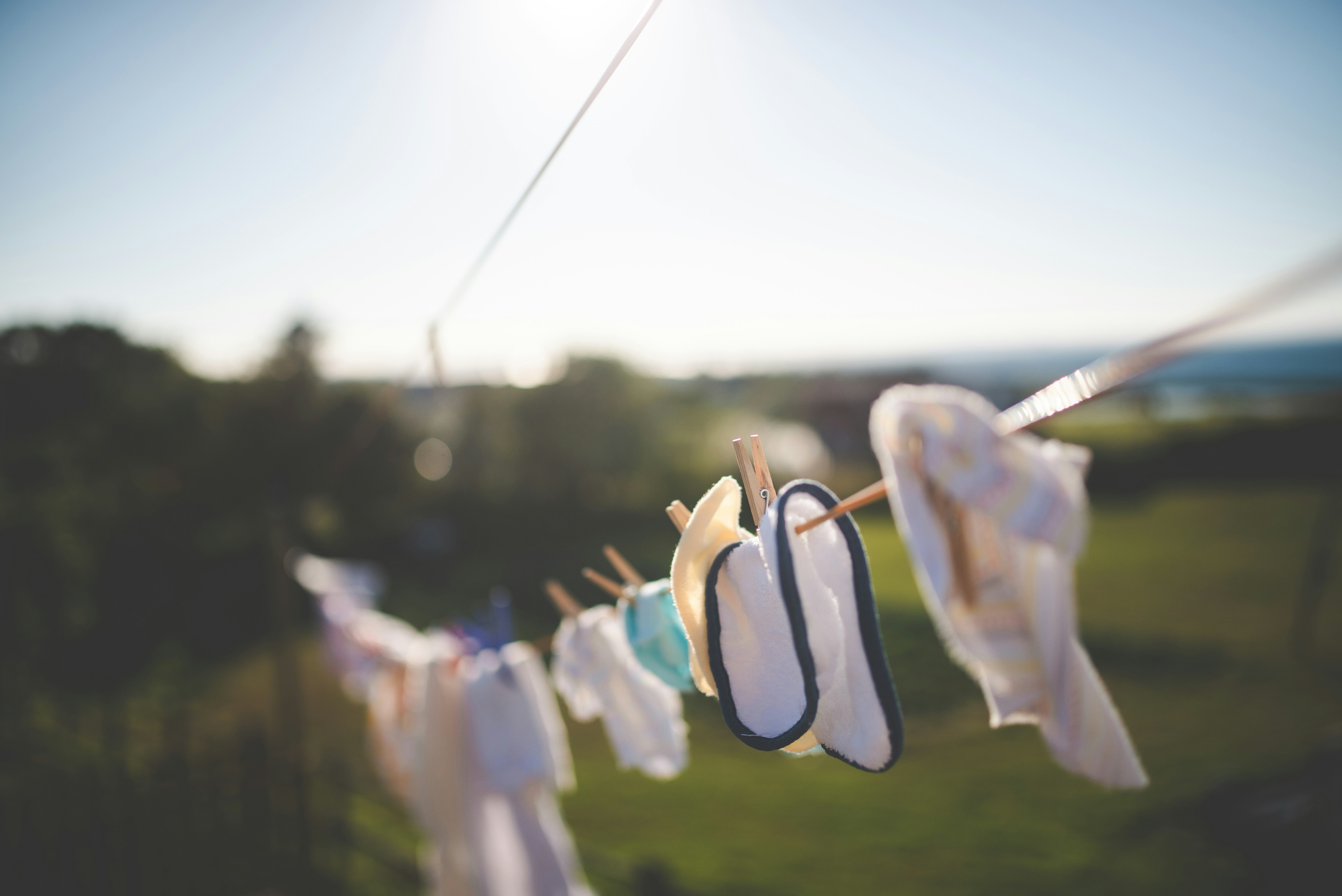white and brown clothes hanged on clothes line