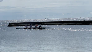Smiling participants enjoying a group session of efoil on calm waters