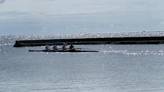 Smiling participants enjoying a group session of efoil on calm waters