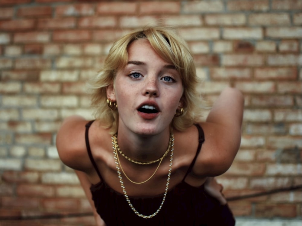 woman in black tank top wearing silver necklace