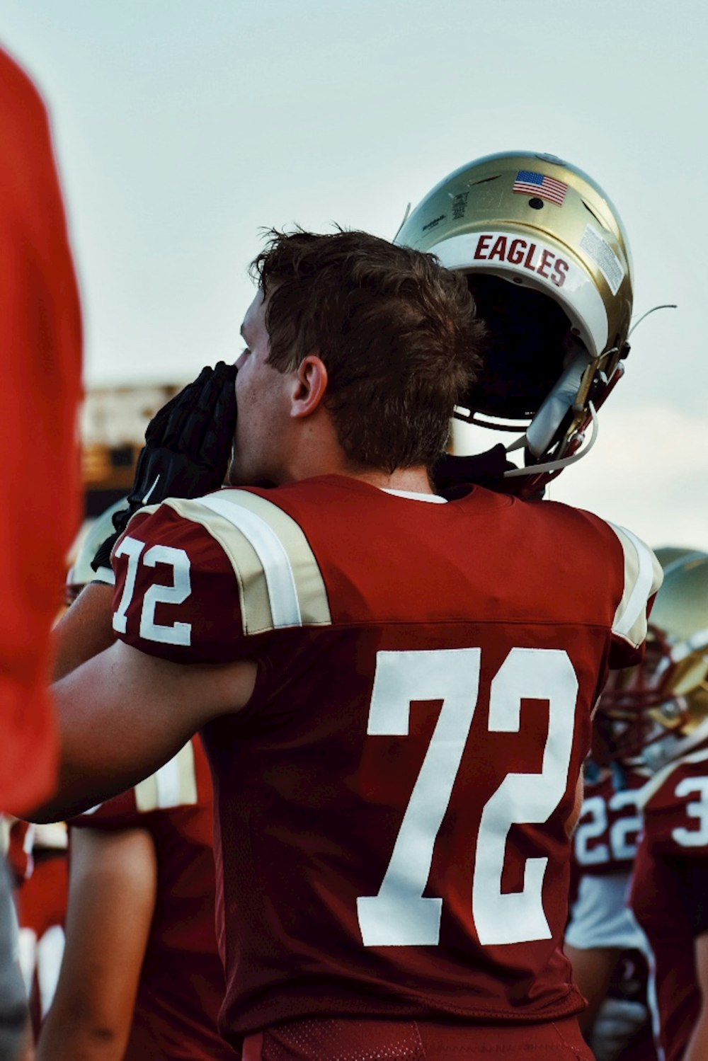 man in red and white football jersey