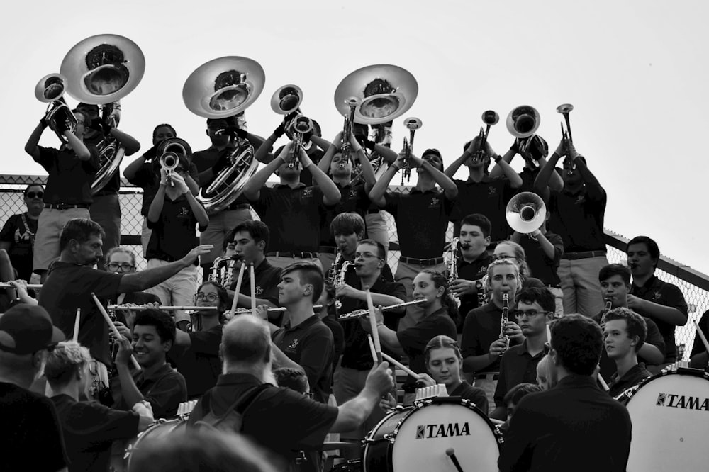 grayscale photo of band performing on stage