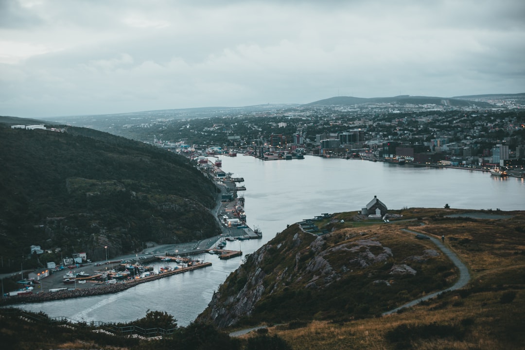 green mountain beside body of water during daytime