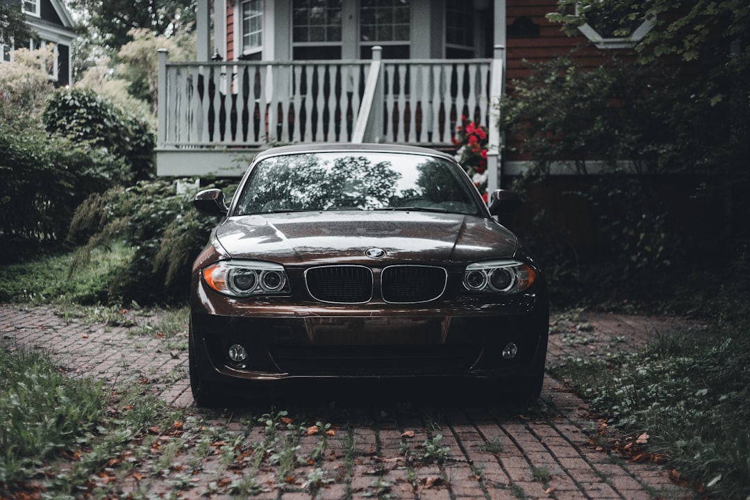 black bmw m 3 parked near white building