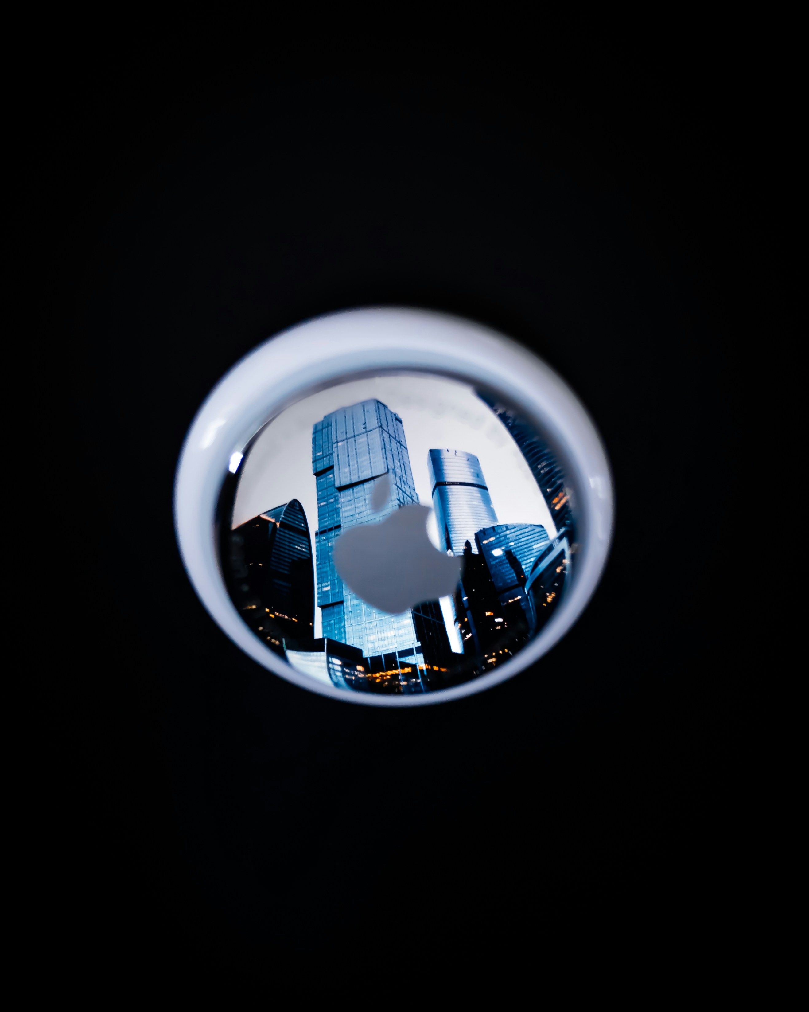 Reflection of buildings on the airtag.