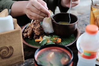 person holding white plastic spoon