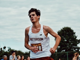 man in white tank top and red shorts