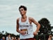 man in white tank top and red shorts