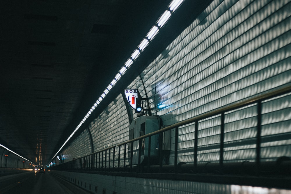 man in black jacket standing on train station