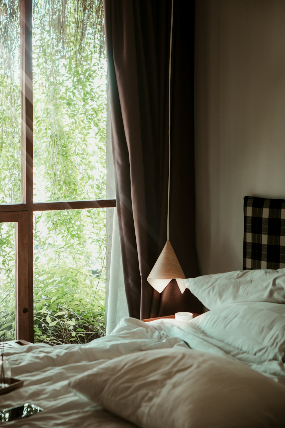 white bed linen near window