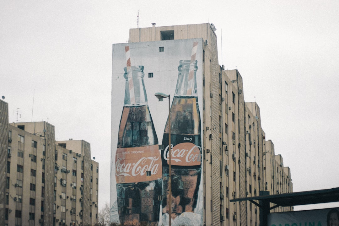 coca cola glass bottles on brown concrete building during daytime