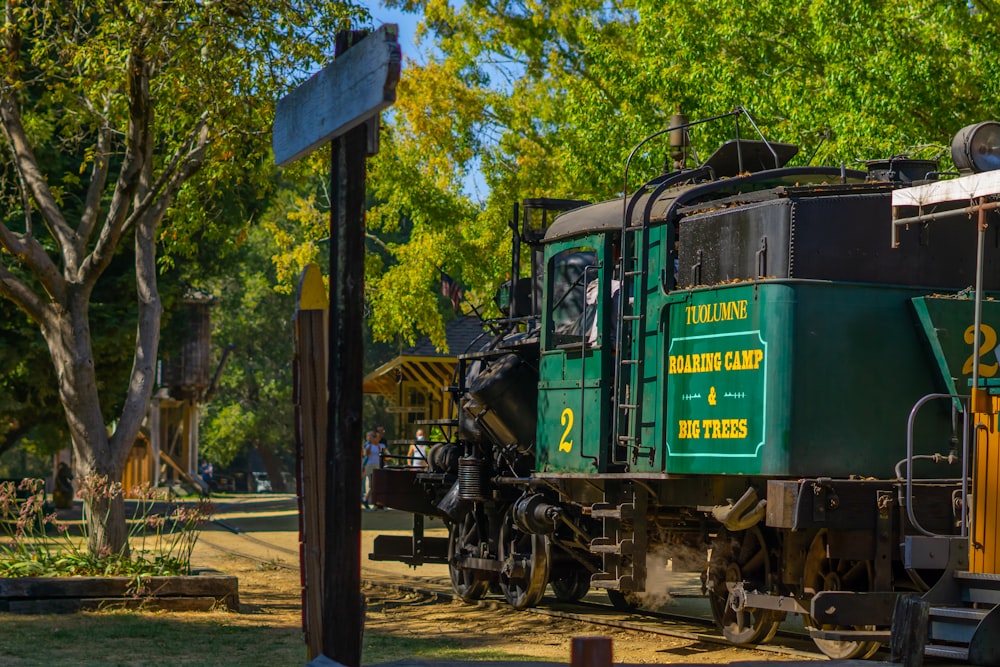 green and black train on rail tracks during daytime