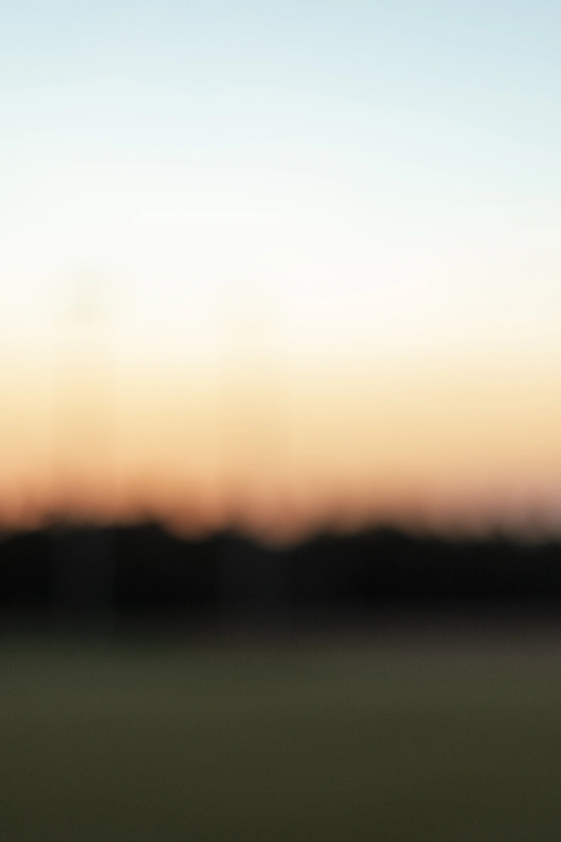 sun setting over green grass field