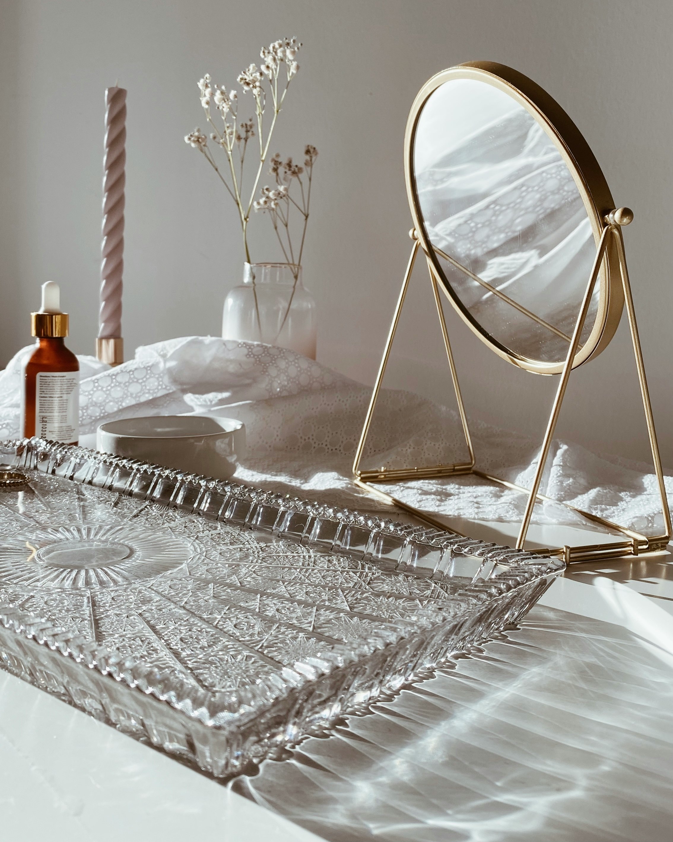 stainless steel framed mirror on white table cloth