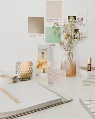 white flowers in clear glass vase on white table
