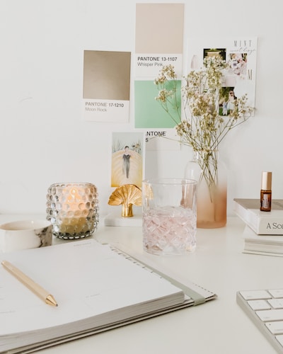 white flowers in clear glass vase on white table