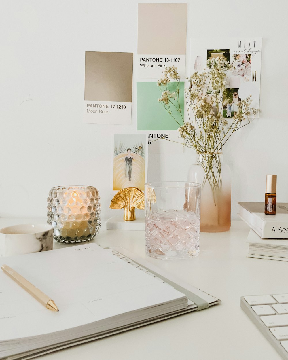 white flowers in clear glass vase on white table