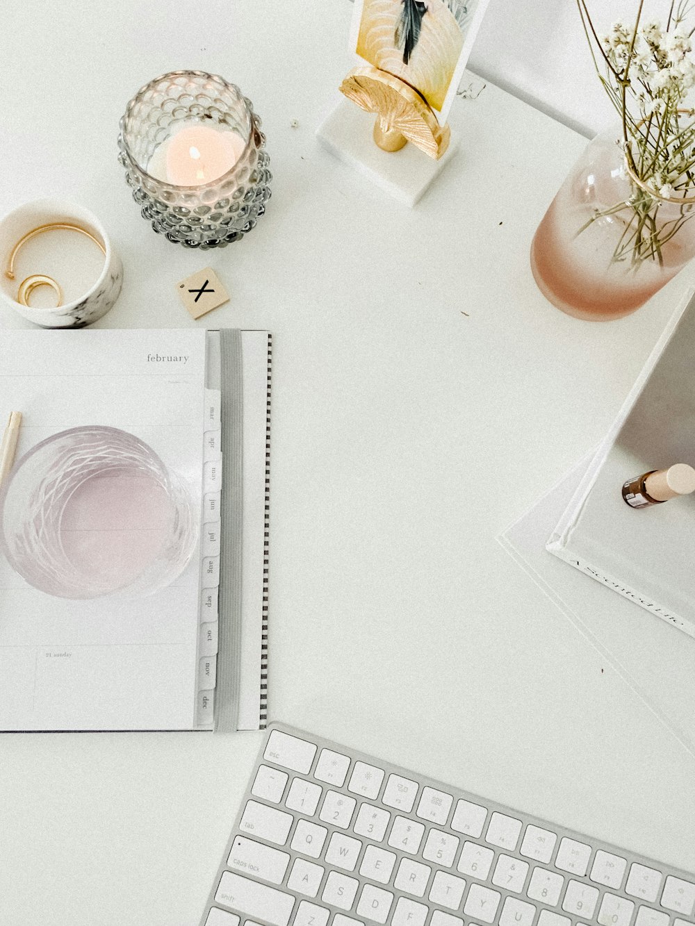 white ceramic cup on white table