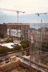 yellow tower crane near building during daytime
