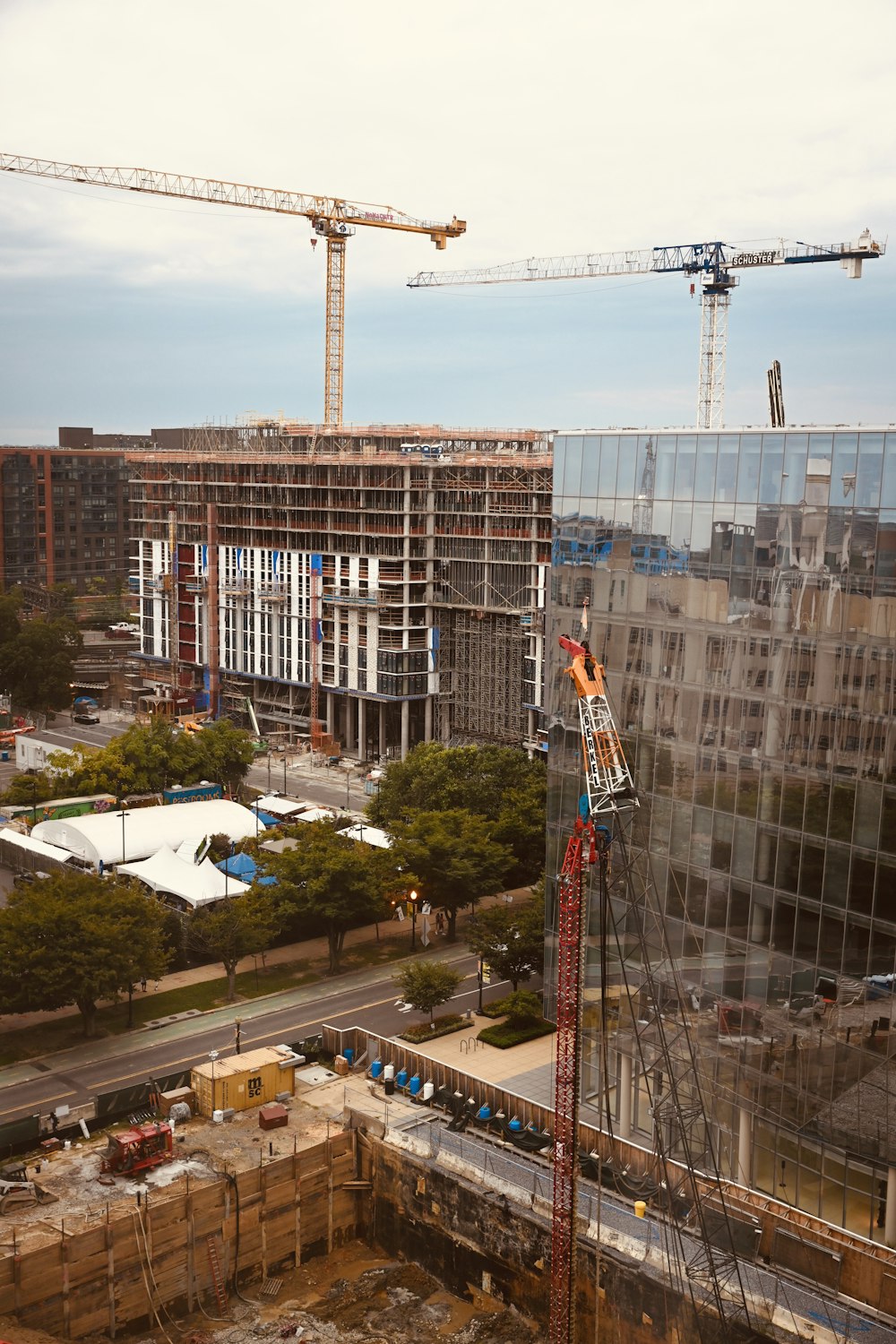 yellow tower crane near building during daytime