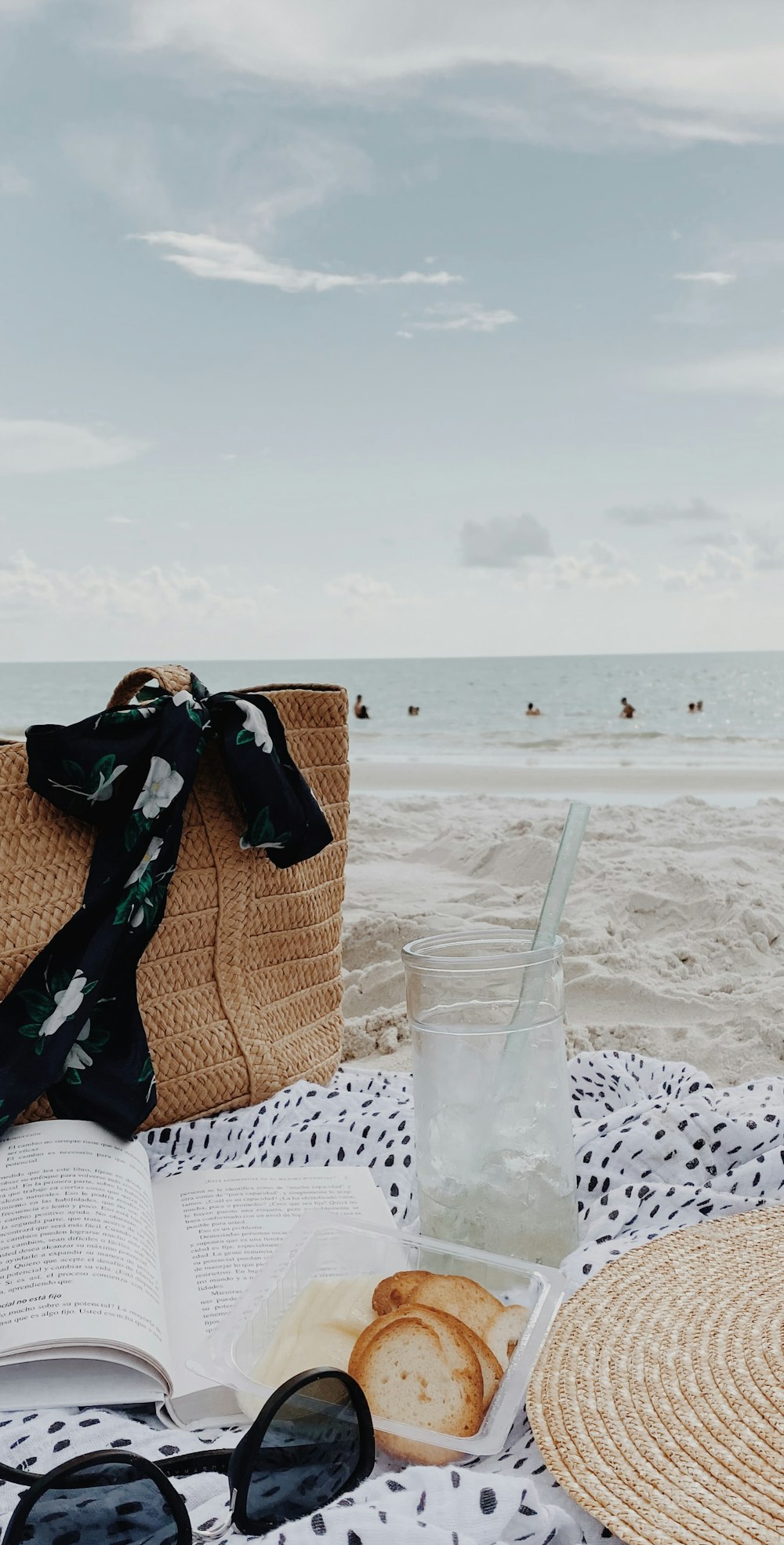 brown and black tote bag on white sand beach during daytime