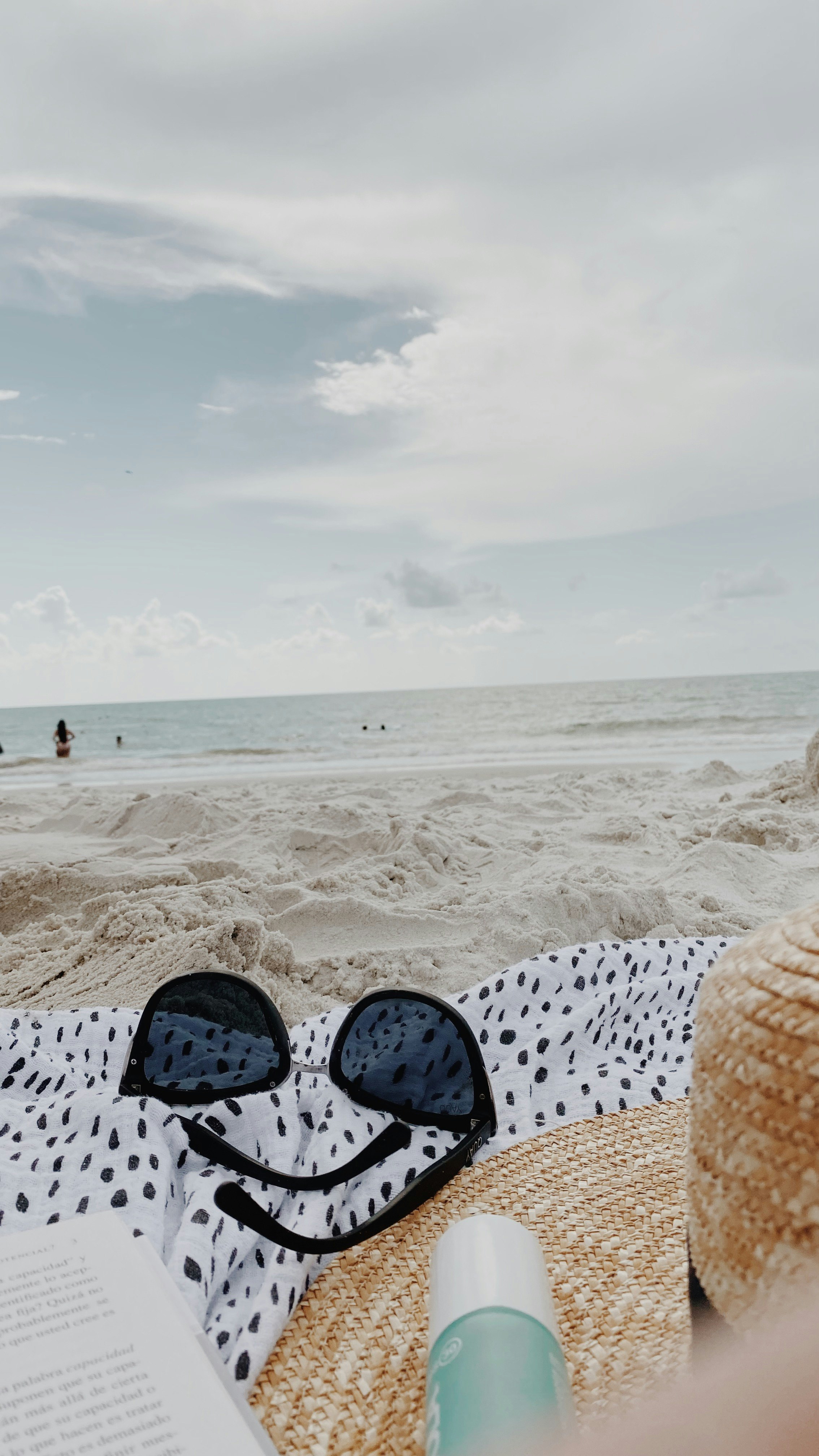 black framed sunglasses on white textile on beach during daytime