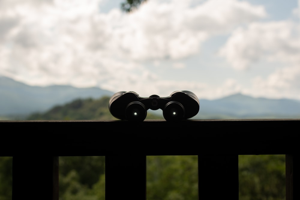 black binoculars on black metal bar during daytime