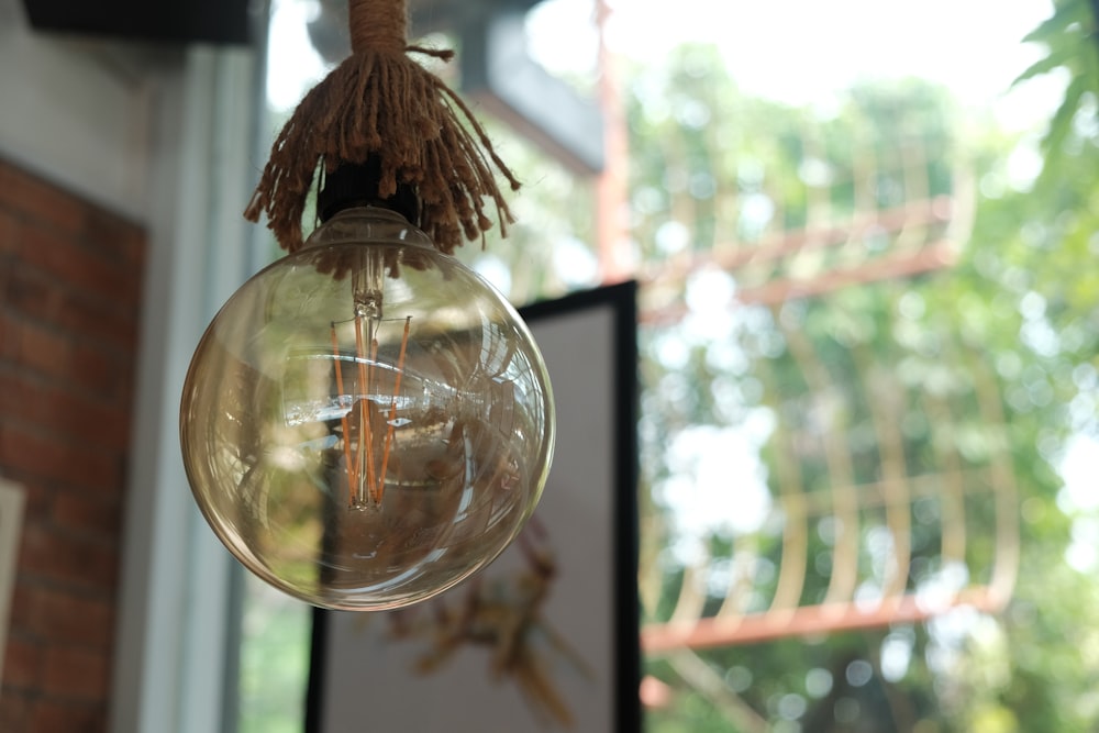 brown wooden hanging decor in front of glass window