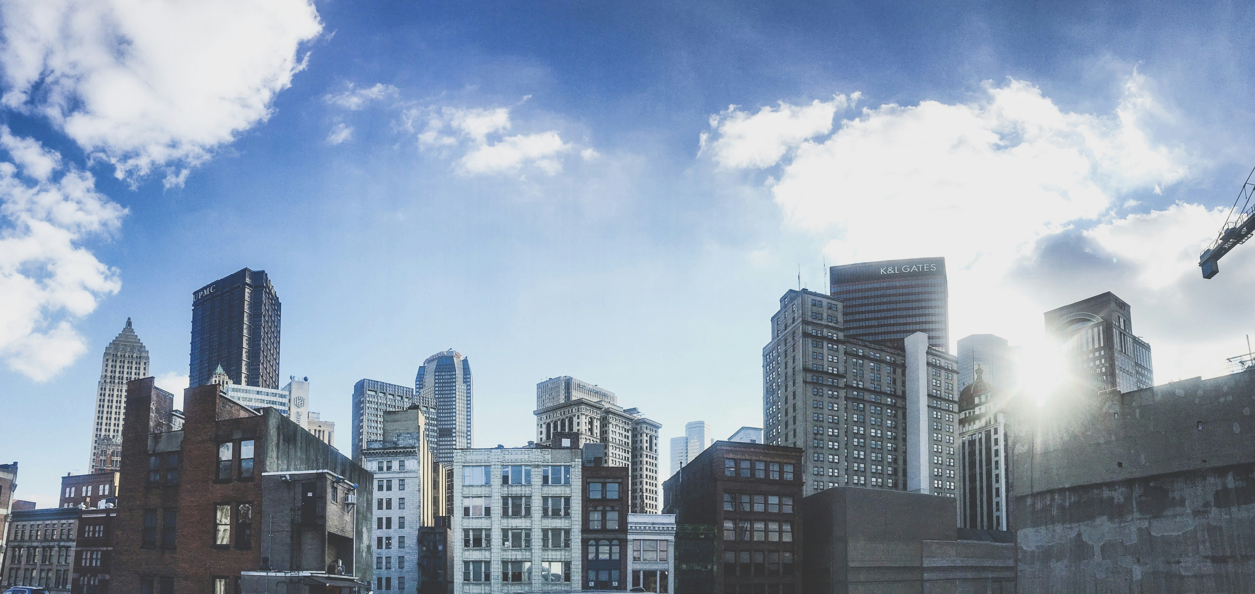 white and black concrete building under blue sky during daytime, Pittsburgh cityscape from a rooftop 