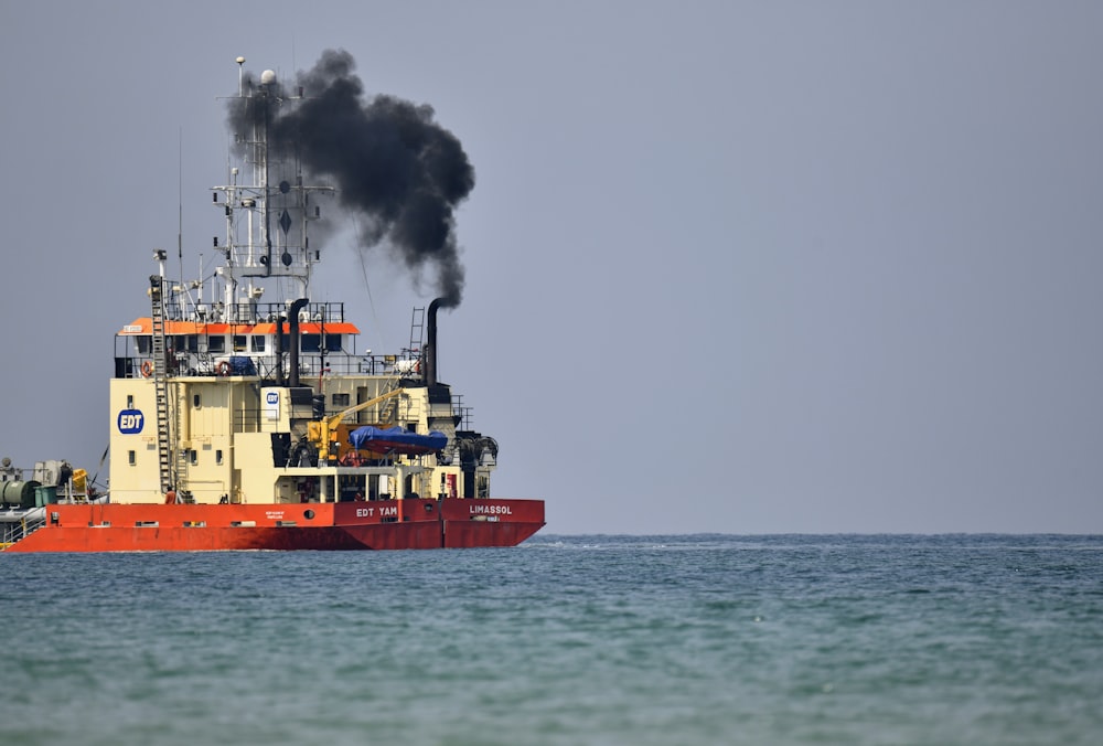 red and white ship on sea during daytime