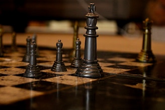 black chess piece on brown wooden table