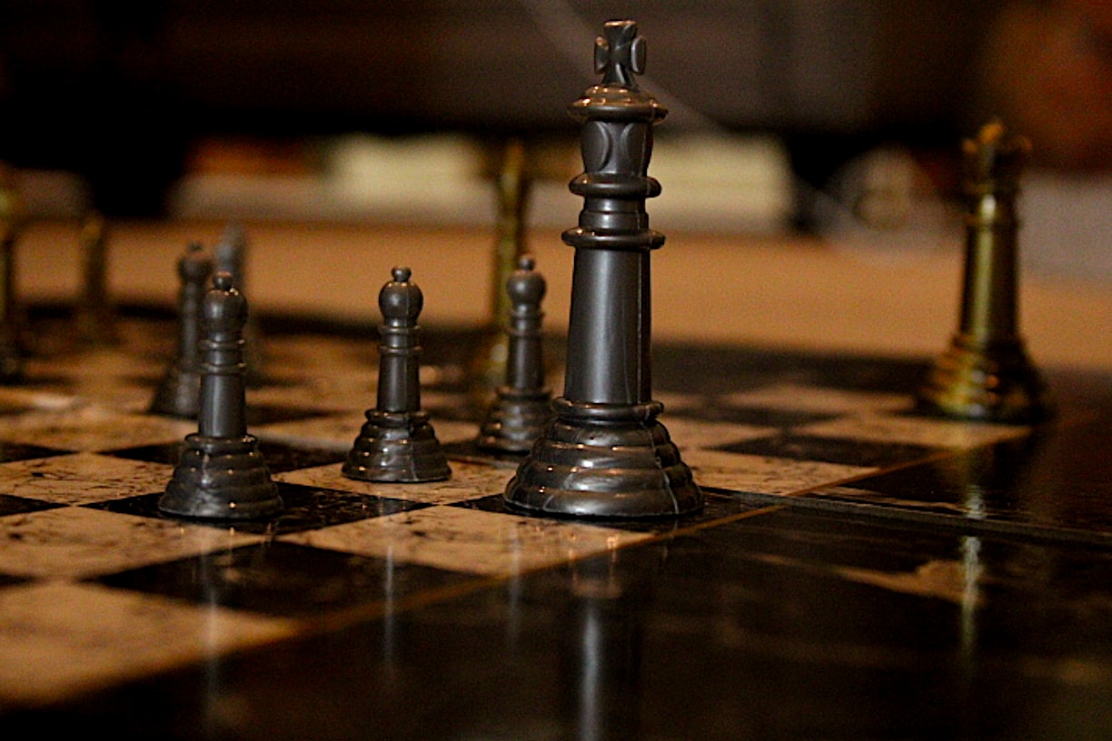 black chess piece on brown wooden table